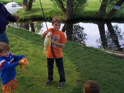 2 boys holding up fish they caught